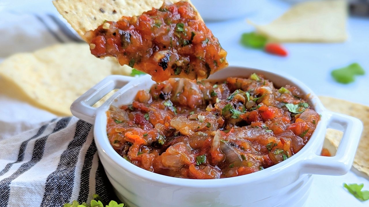 an unsalted chip dipping into salt free roasted salsa without any salt or preservatives.