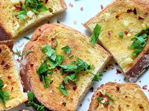 no salt garlic bread recipe with fresh garlic low sodium bread butter and parsley on a plate broiled or toasted in the oven