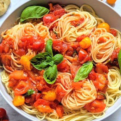 low sodium tomato sauce recipe with basil fresh tomatoes canned tomatoes in a bowl with a napkin