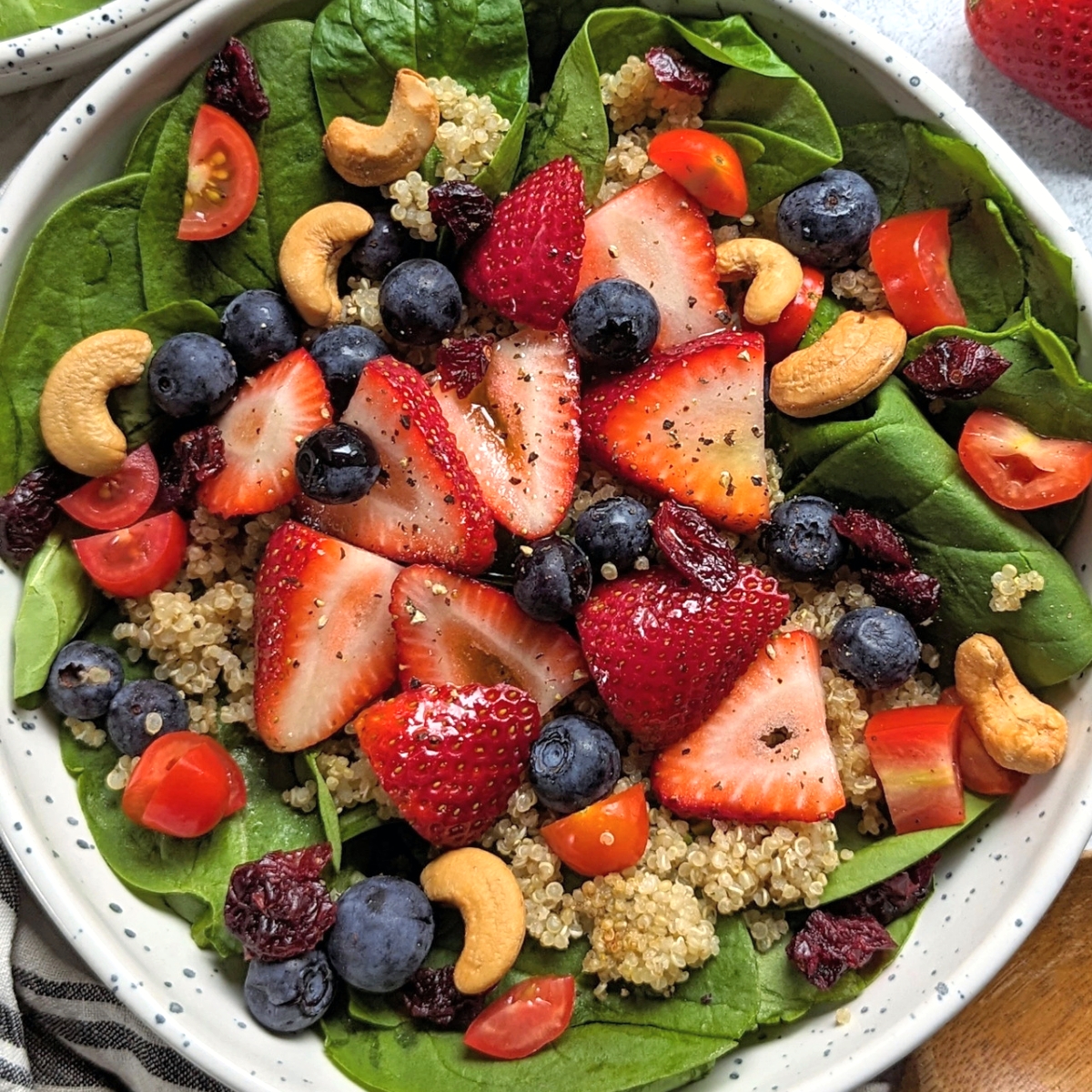 low sodium strawberry salad with cashews blueberries spinach greens and quinoa in a homemade lemon dressing