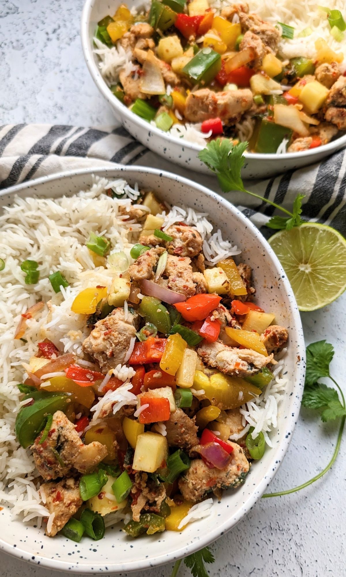 low salt chicken with pineapples green bell peppers, green onions, and peppers over white steamed rice for a low sodium dinner idea