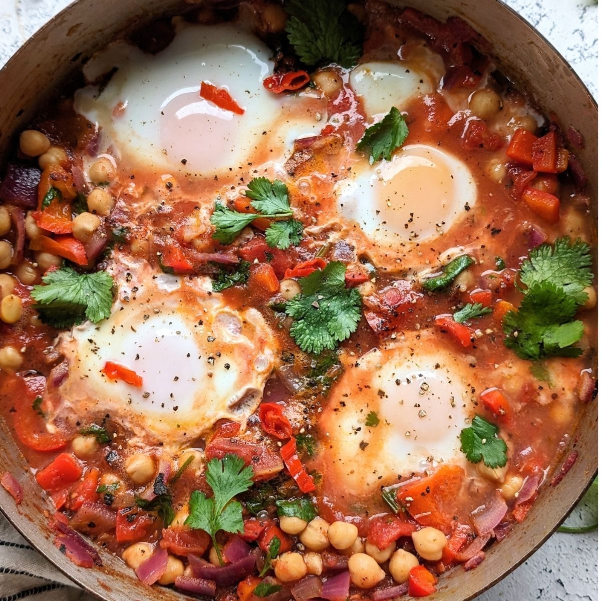 low sodium eggs baked in tomatoes chickpeas with cilantro and red chili flakes