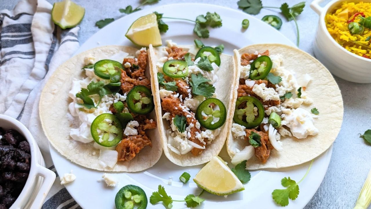 low sodium mexican street tacos with tinga chicken and a topping of low salt cheese cilantro and fresh lime juice