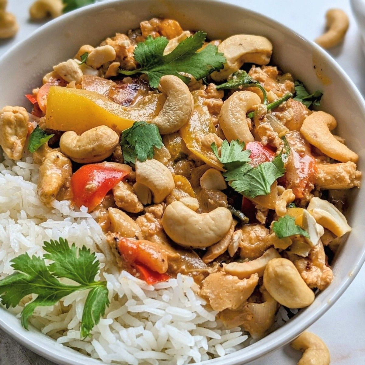 low sodium cashew chicken recipe with a creamy sauce served over white rice with cilantro