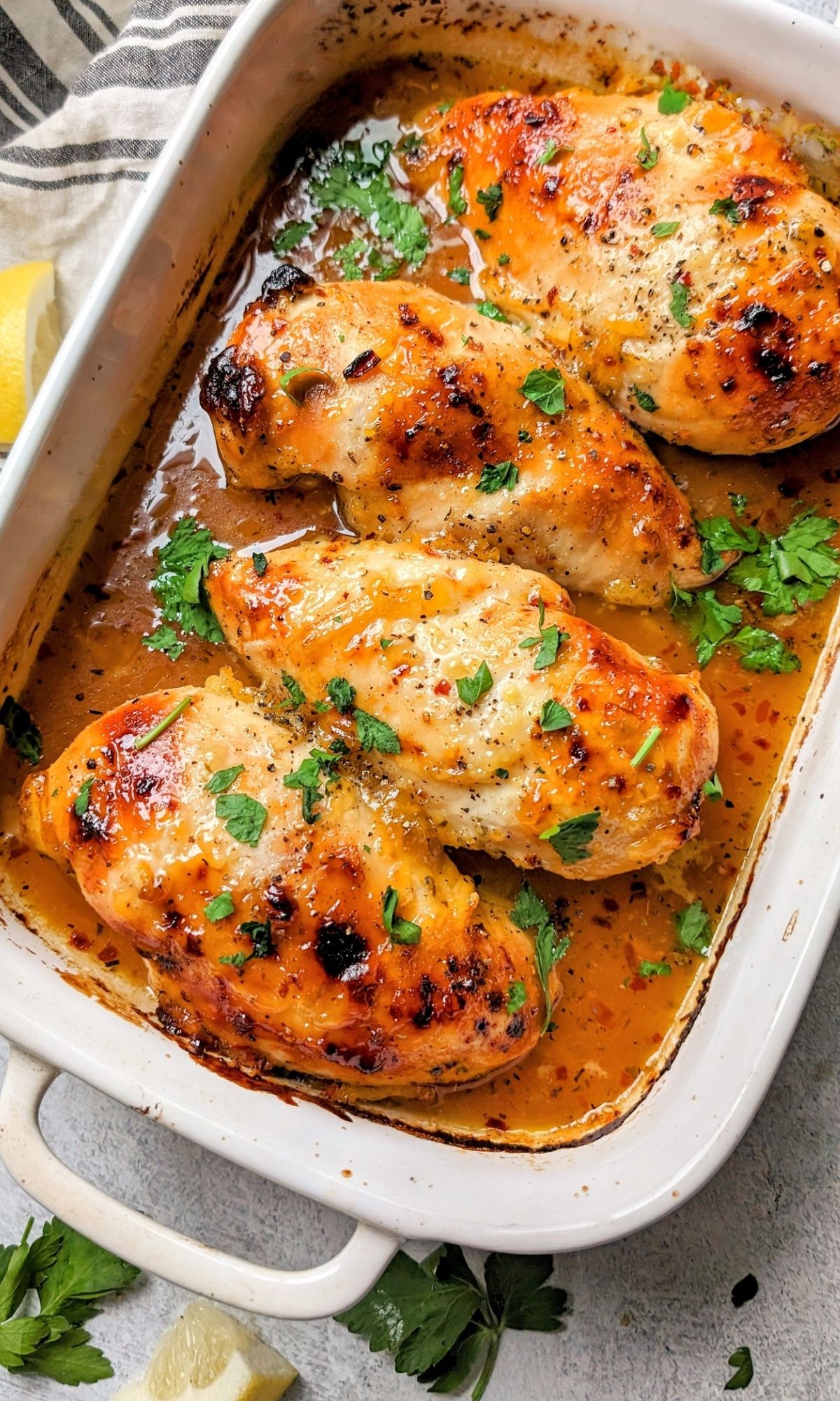 low salt baked chicken with apricot fruit glaze and fresh herbs in a baking dish that has been roasted in the oven