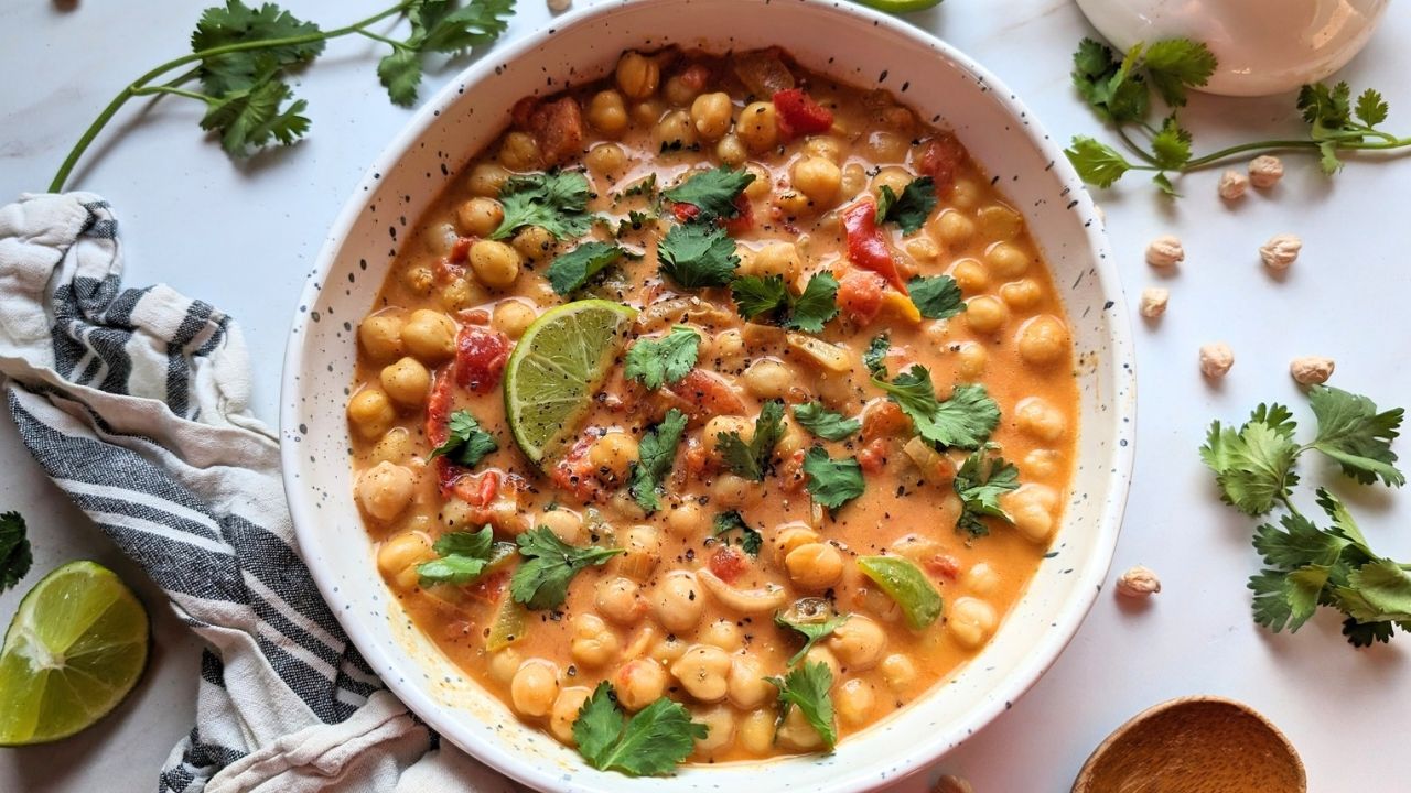 a bowl of low sodium curry with chickpeas and fresh herbs and spices loaded with fresh chopped cilantro for a easy weeknight meal