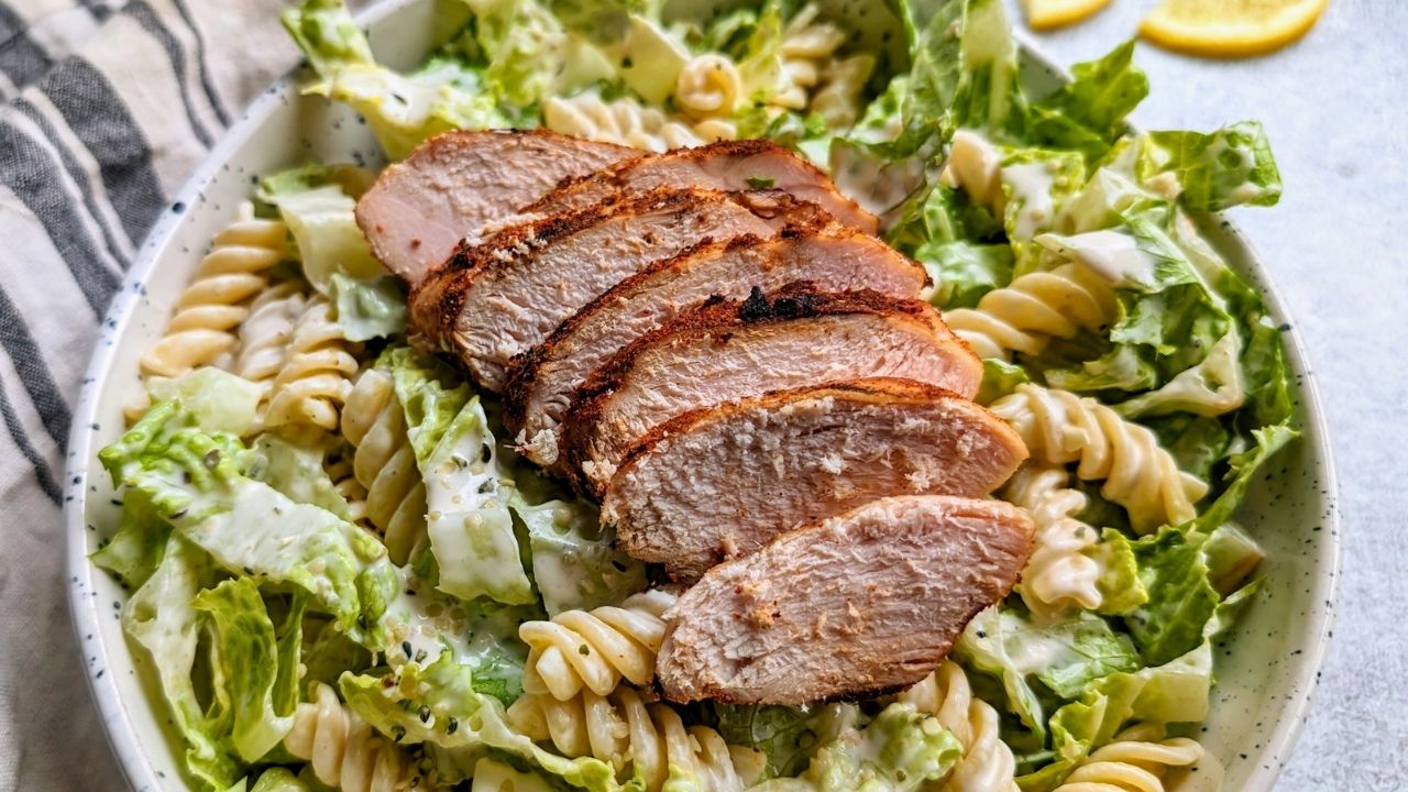 low sodium caesar salad with romaine lettuce and cooked rotini pasta with grilled chicken and a healthy greek yogurt dressing