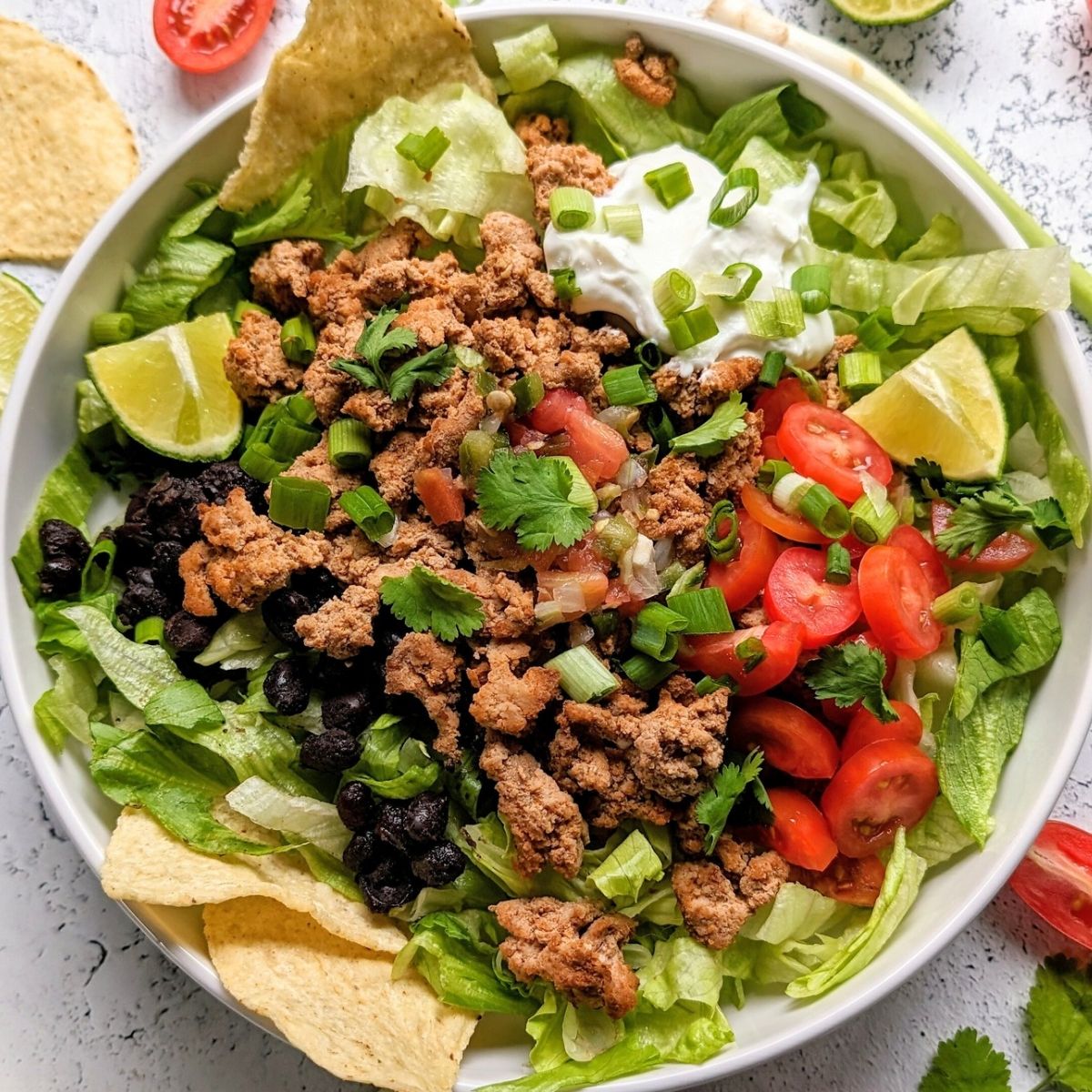 low sodium taco bowl recipe with Lettice no salt added taco meat tomatoes lime sour cream and avocado
