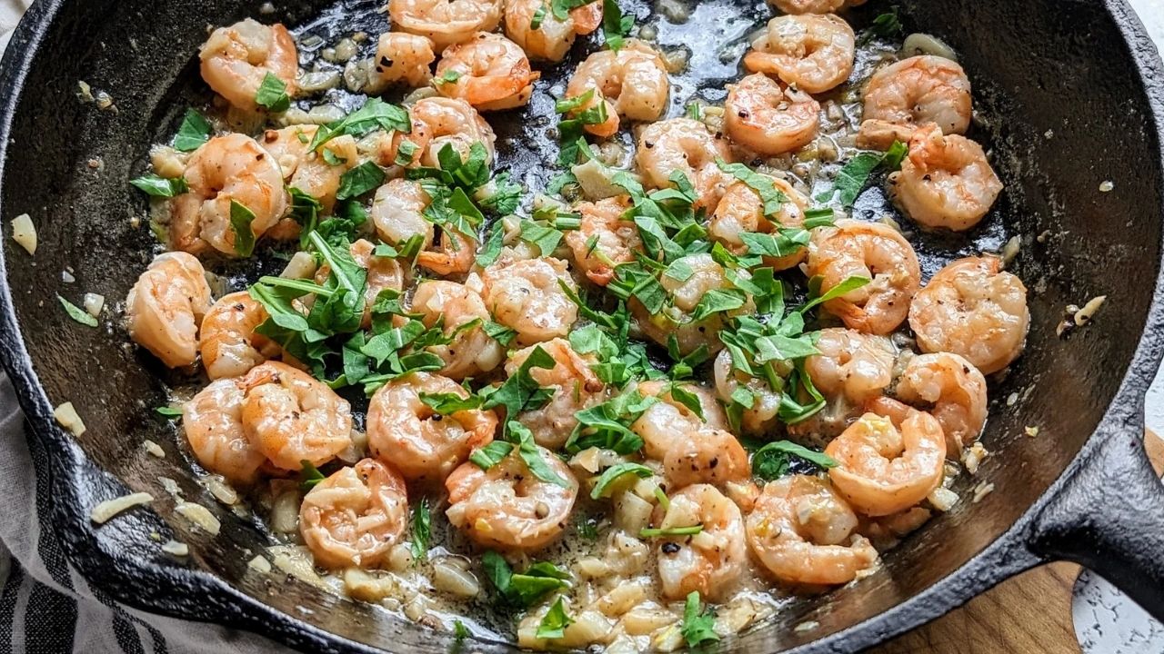 low salt shrimp in a cast iron skillet cooked with fresh herbs and spices for a tasty low sodium scampi