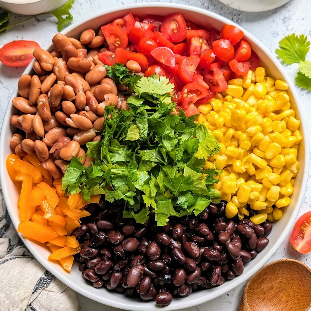 low sodium dips with beans, corn, tomatoes, peppers, and fresh herbs in a bowl divided by color