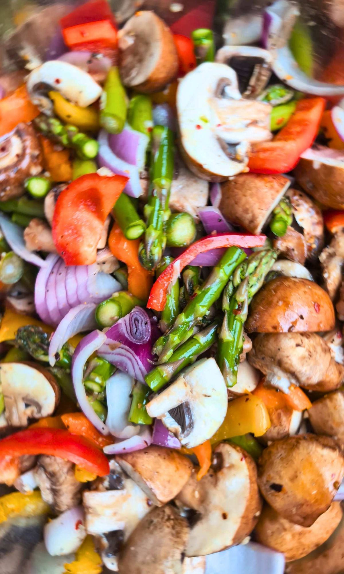 chopped vegetables like mushrooms, asparagus, onions, garlic, and bell peppers.