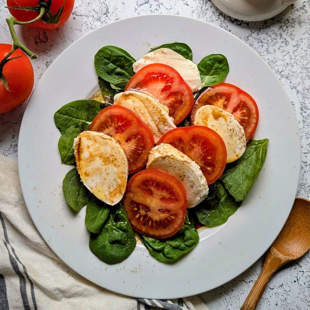 low sodium caprese salad with tomatoes and fresh mozzarella cheese with basil, balsamic vinegar, and olive oil.