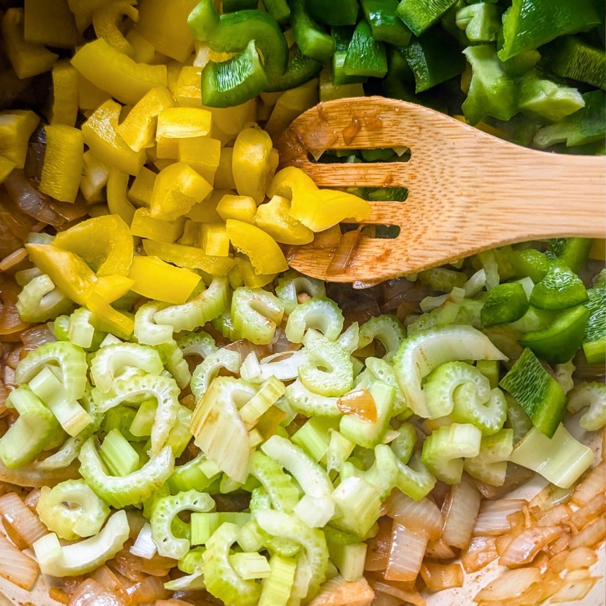 a pot with caramelized onions, chopped celery, and bell peppers for a low salt jambalaya.