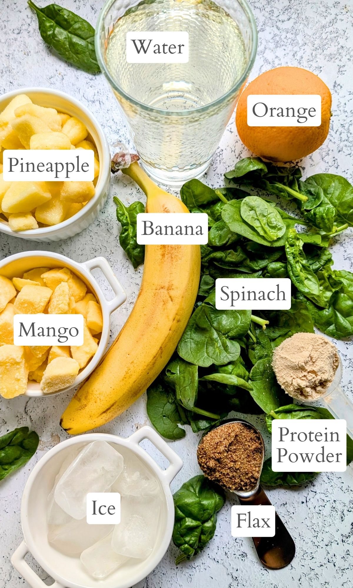 ingredients for low sodium smoothie like banana, pineapple, mango, protein powder, and oranges.