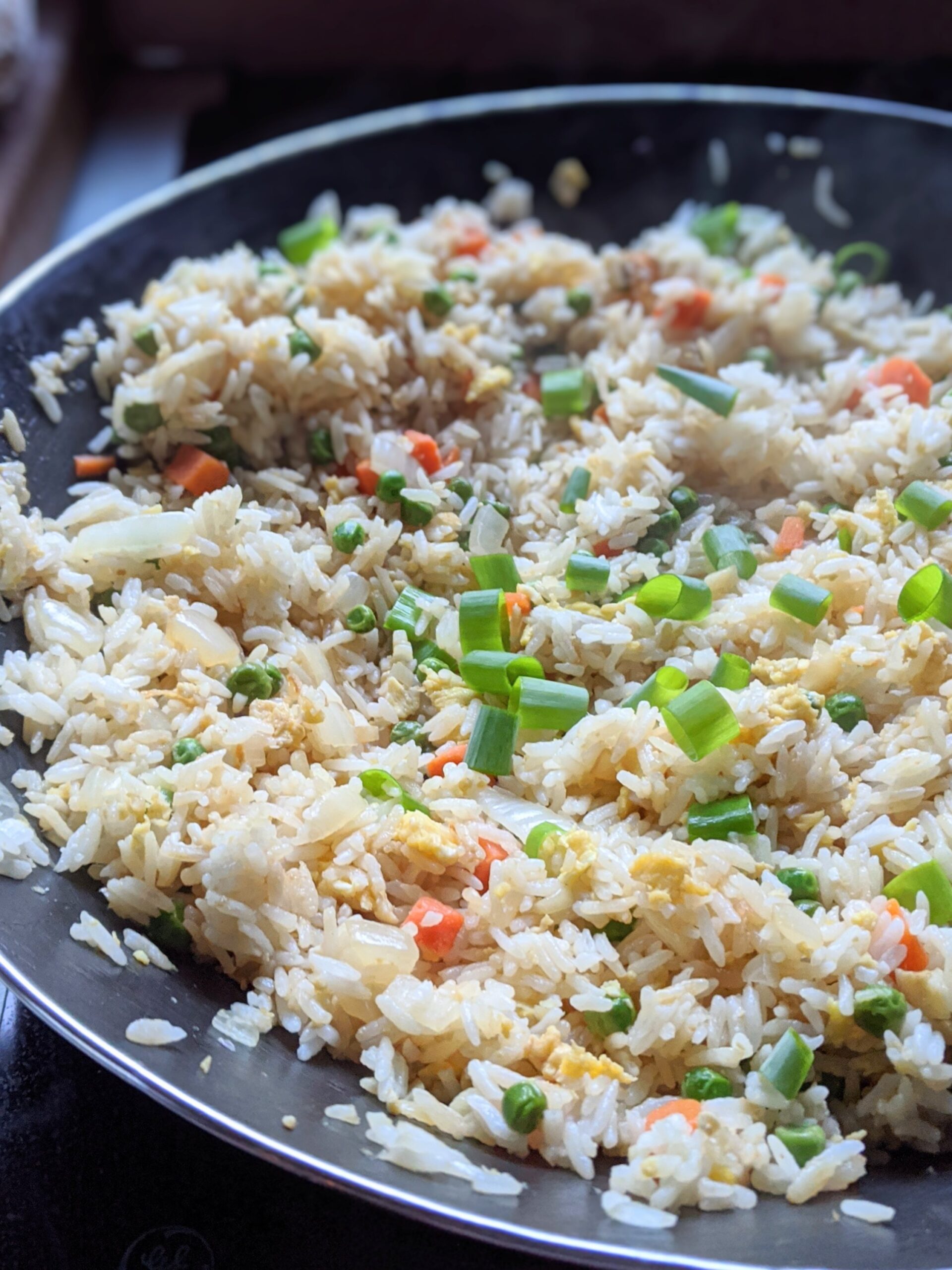 low sodium rice recipes in a wok with a wooden spoon.