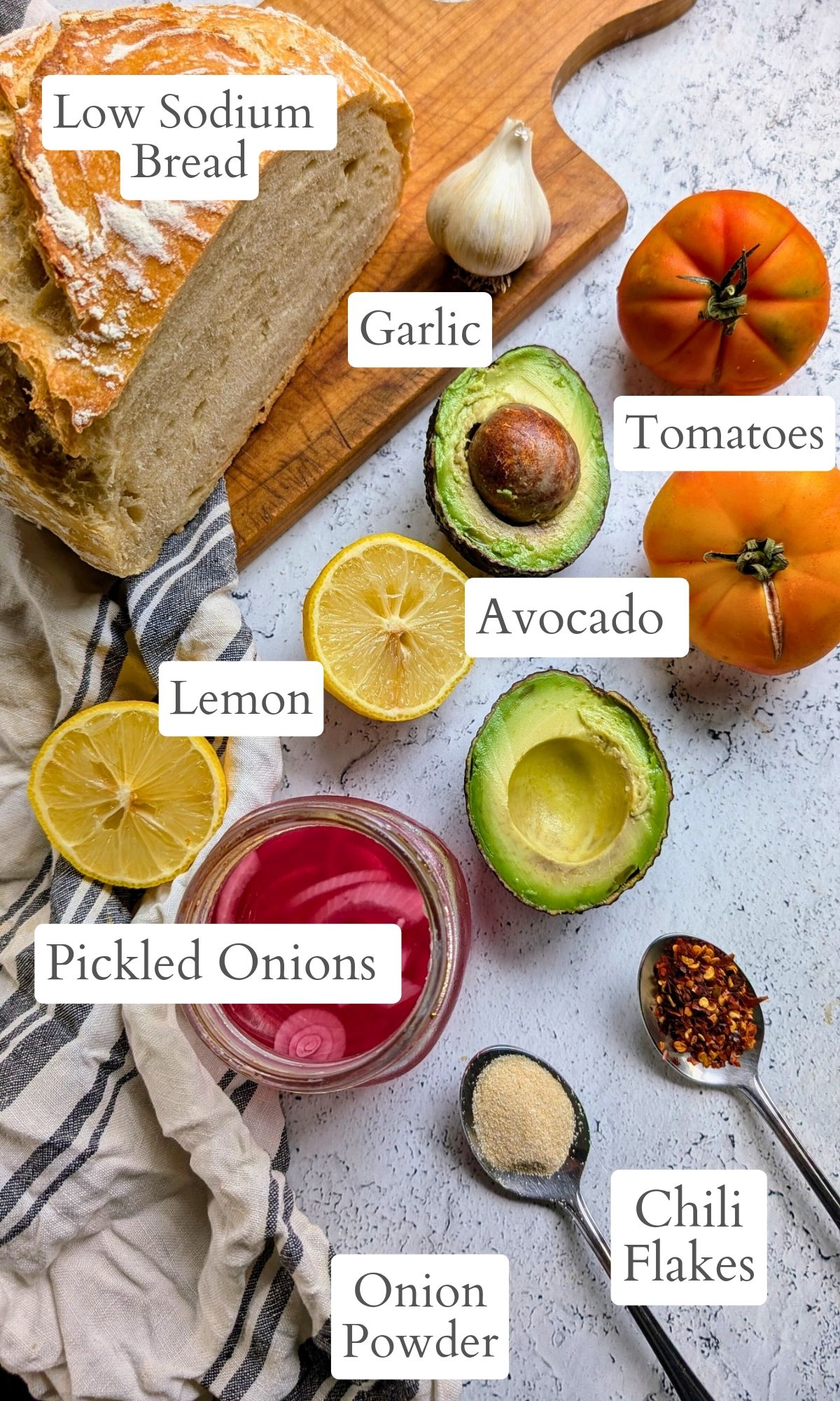 avocado toast ingredients: low sodium bread, avocado, tomatoes, pickled onions, onion powder, garlic powder, and chili flakes.