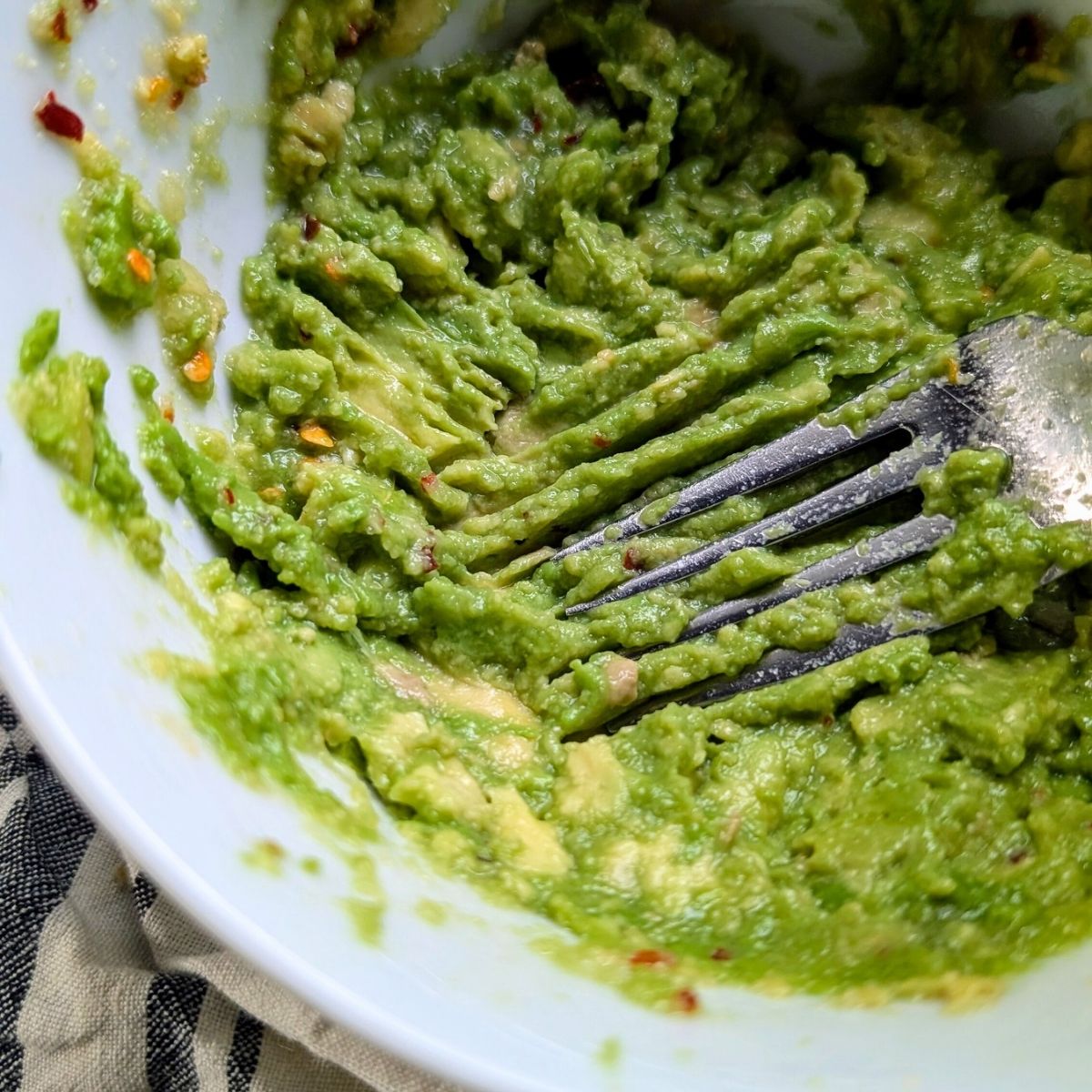 salt free avocado mashed with a fork for low sodium avocado toast.