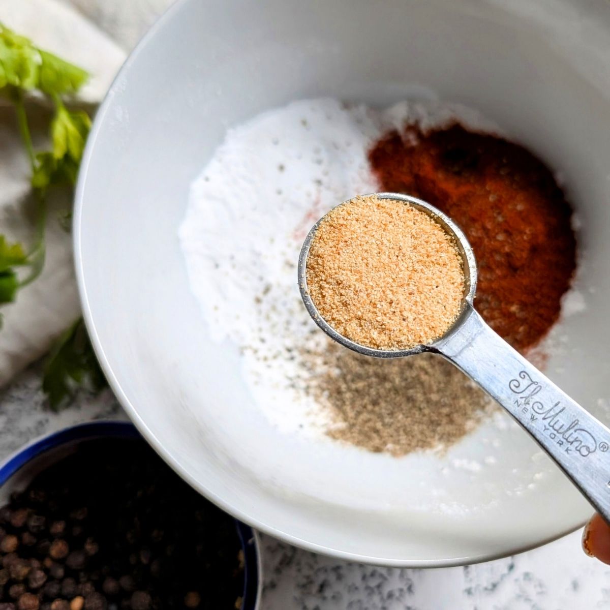 In a small bowl the no salt spice blend is mixed: chili powder, garlic powder, black pepper, and sodium free baking powder.