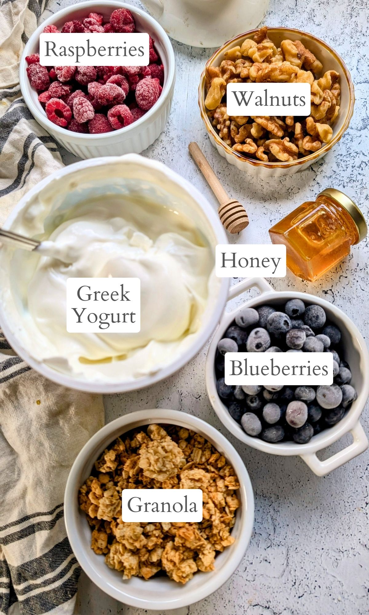 ingredients for low sodium breakfast bowls with yogurt berries nuts and granola.