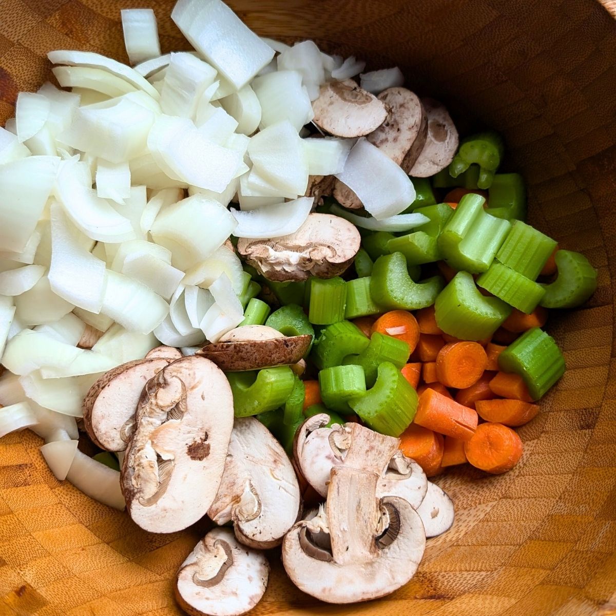 chopped salt free vegetables added to a large bowl to make pot roast.