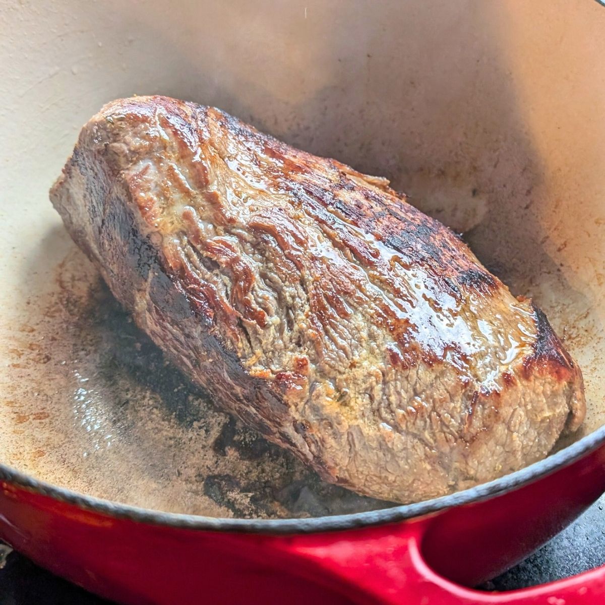 unsalted pot roast seared in a dutch oven pot betting brown and juicy