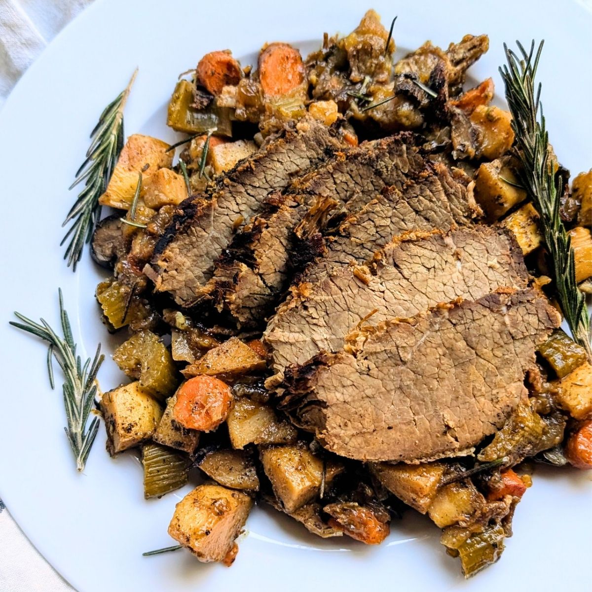 low salt pot roast recipe with potatoes and root vegetables and rosemary herbs.