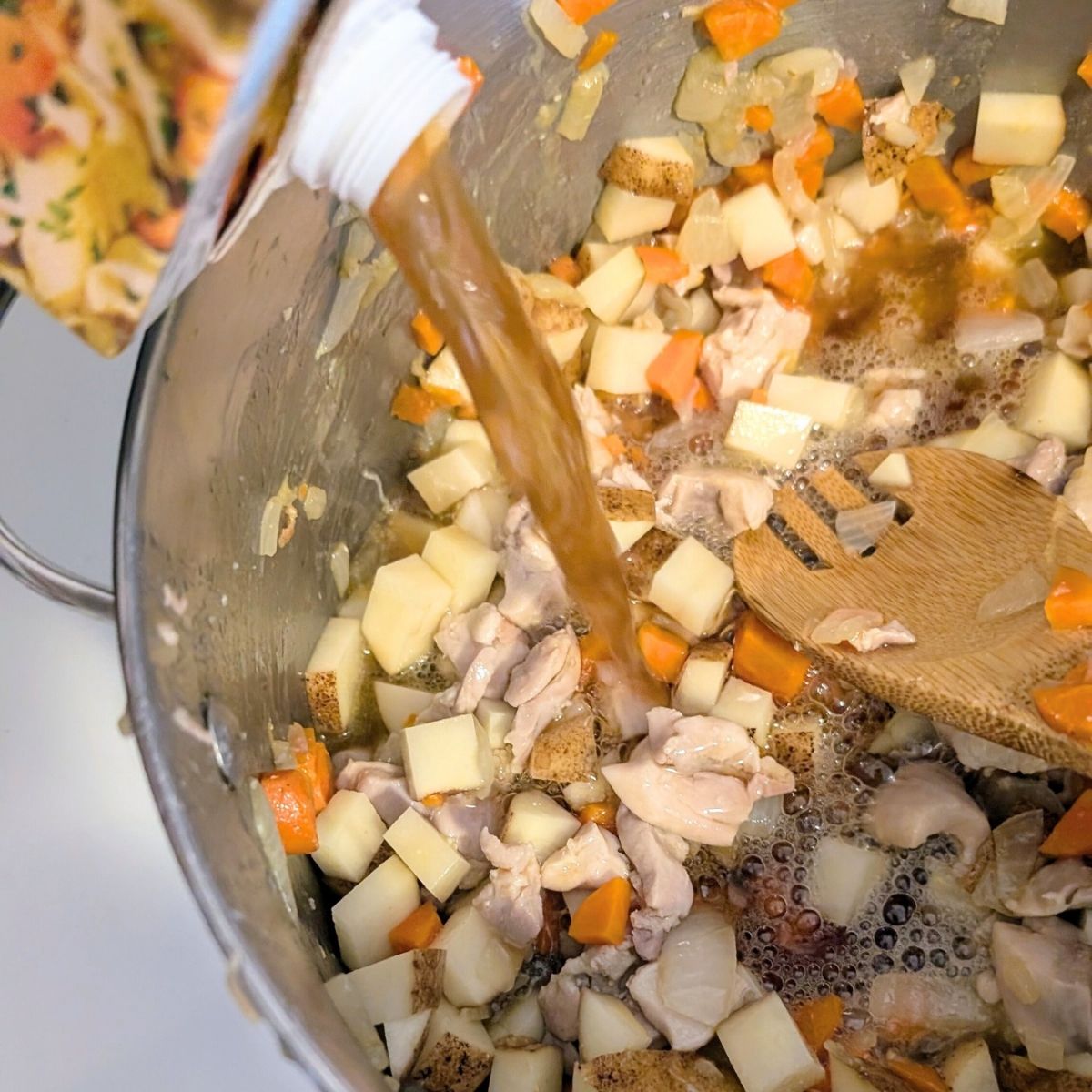 potatoes and no salt added vegetable stock added to a pot for low sodium chicken and dumplings.