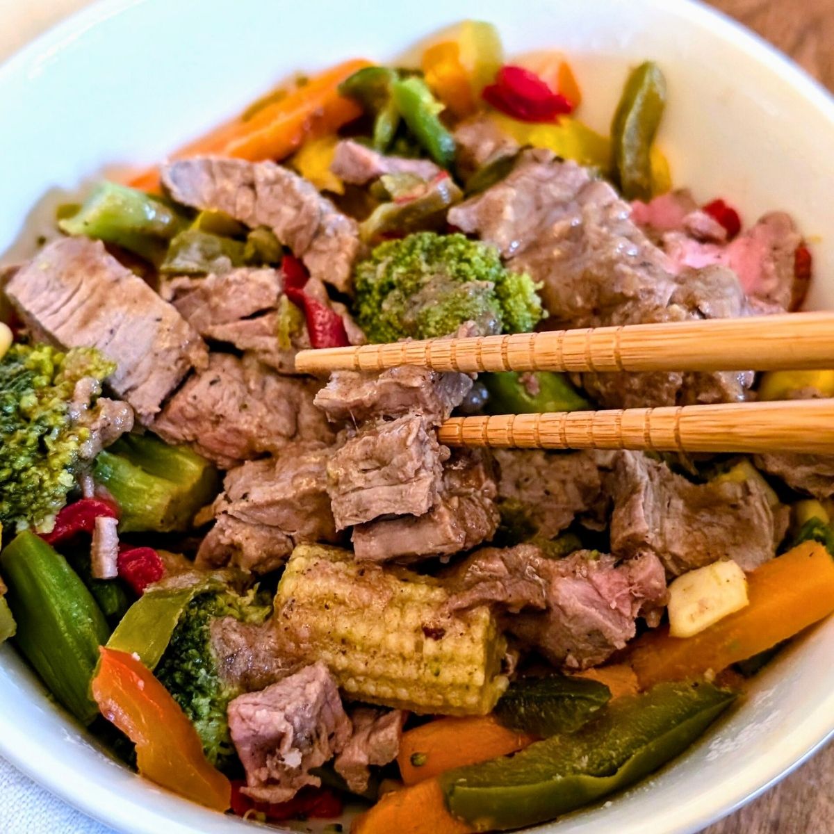 low sodium stir fry with beef and vegetables with corn and carrots, bell peppers, and onions.