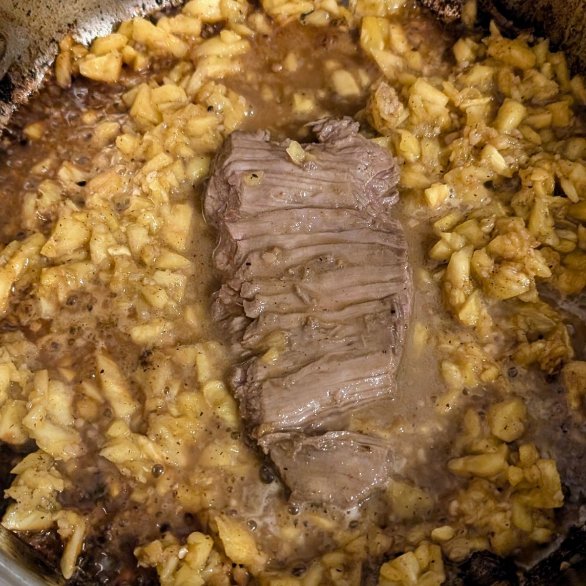 low sodium stir fry sauce being poured over steak for a low salt dinner