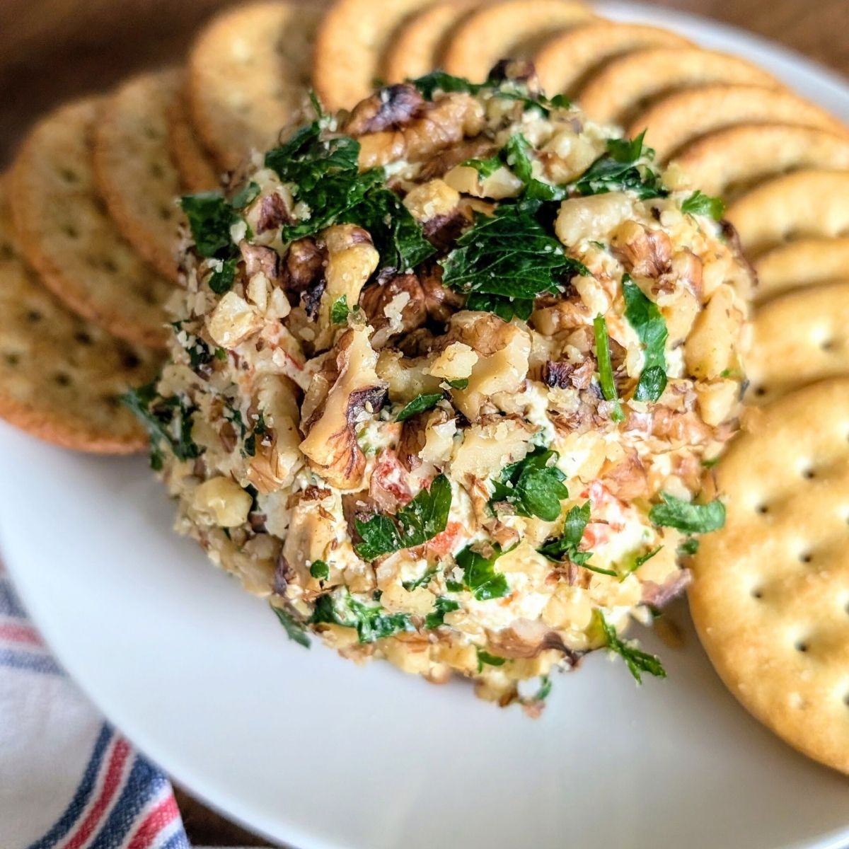 a low sodium appetizer cheese ball dip with crackers on a plate for the holidays