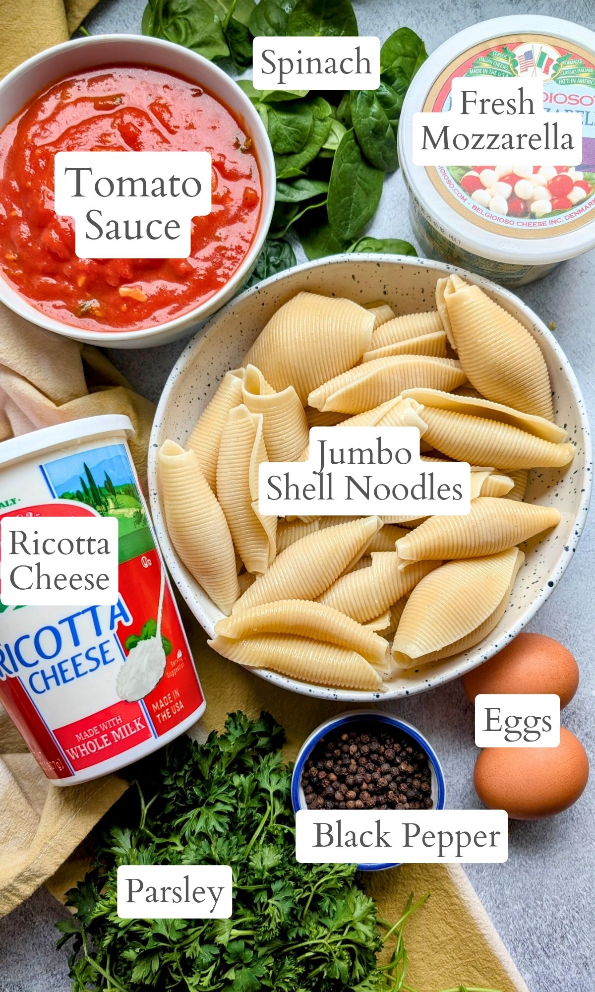 ingredients for low sodium shells like pasta, tomato sauce, ricotta cheese, eggs, mozzarella cheese, spinach, and parsley.