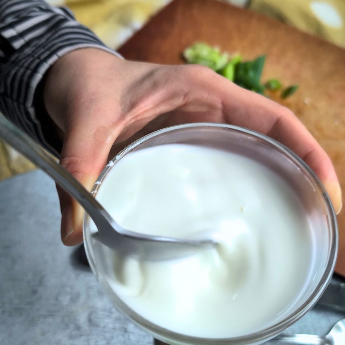 a spoon stirring a dish with corn starch to thicken low sodium egg drop soup