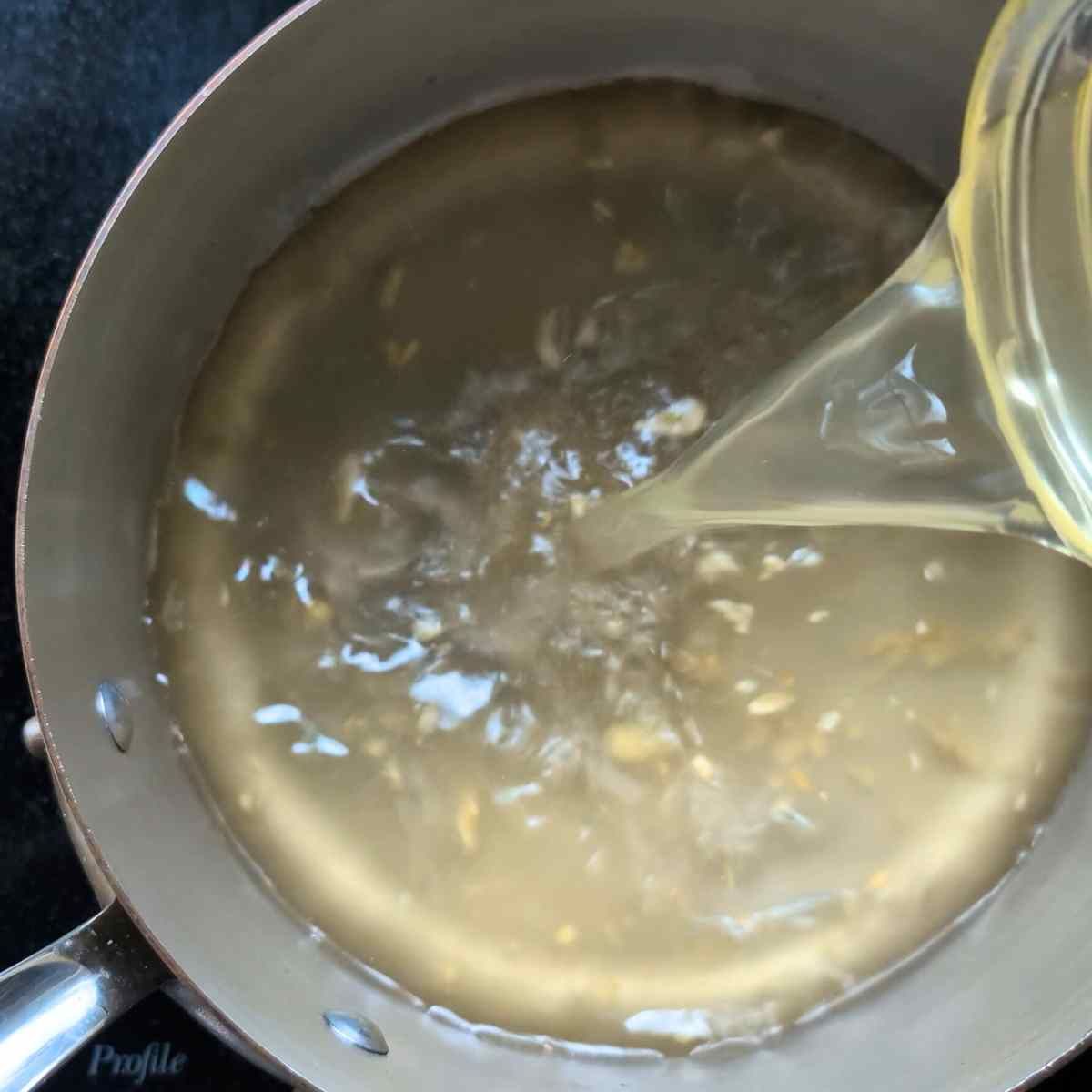 low sodium chicken stock in a pot boiling to make low sodium egg drop soup recipe 