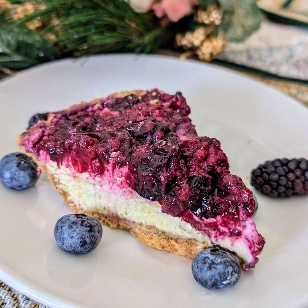 low sodium cheesecake with fresh blueberries and blackberries on a plate for sweetness and tartness