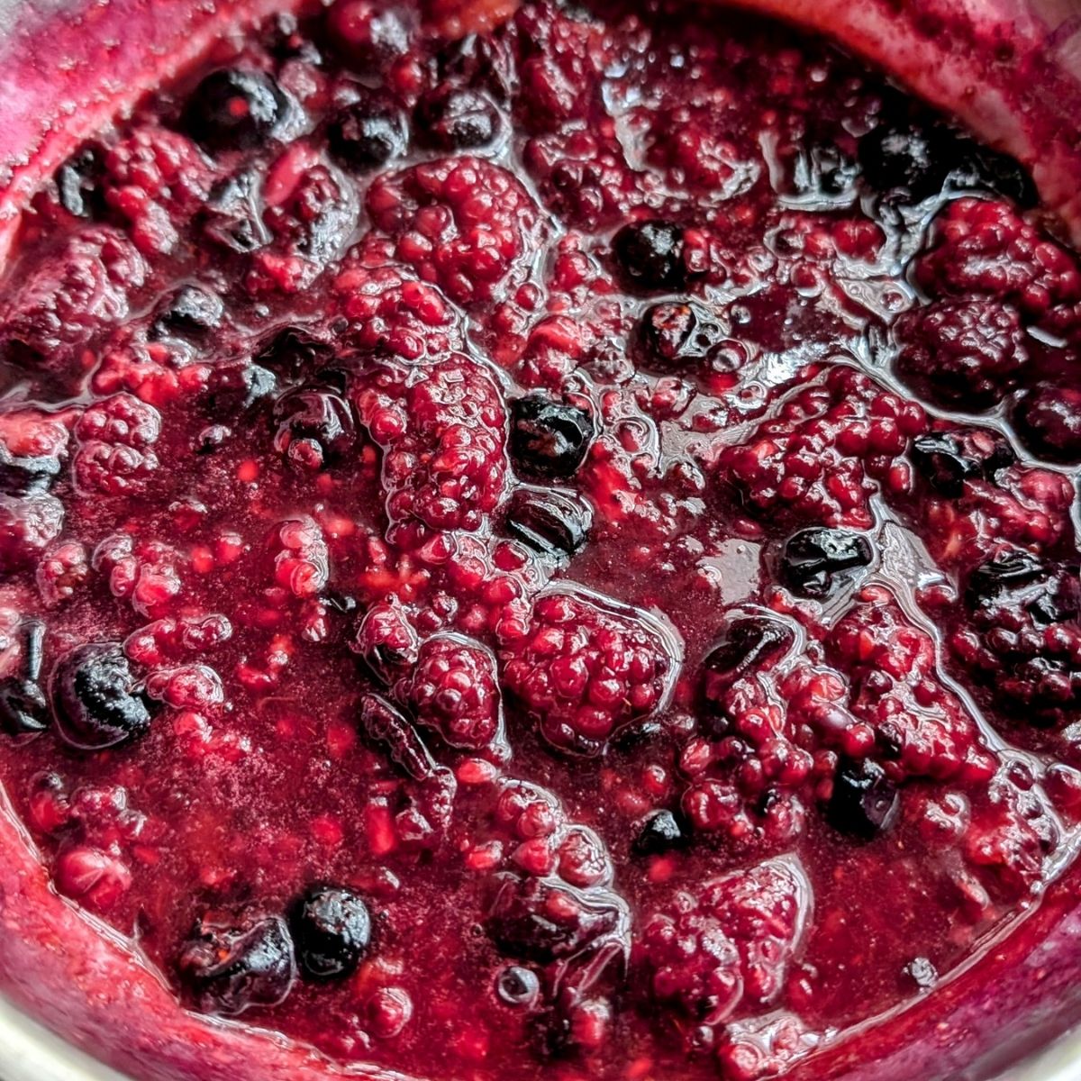 low sodium berry compote with blueberries and blackberries in a pan ready for cheesecake.