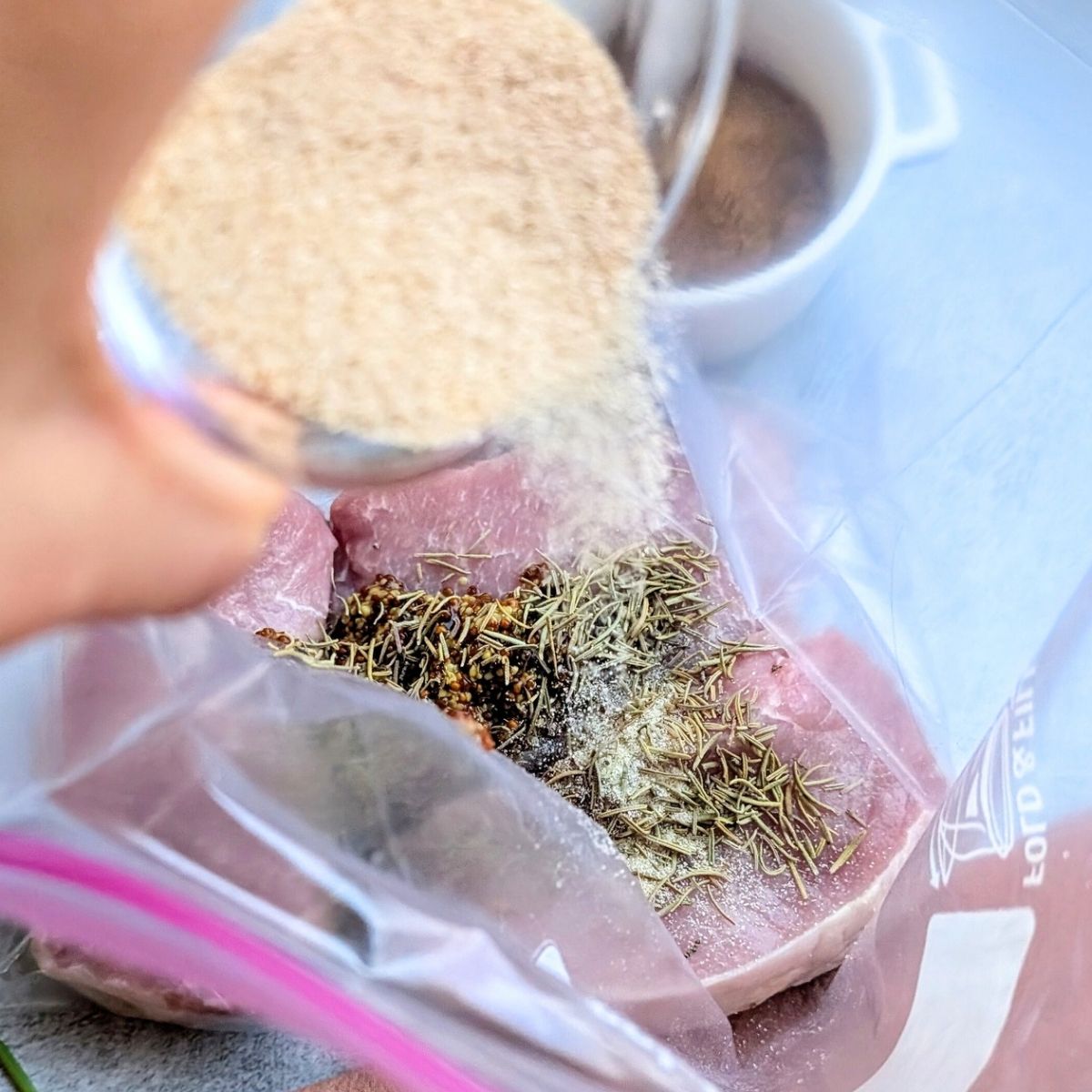 pork chops in a bag with marinade and spices like onion powder garlic powder and rosemary