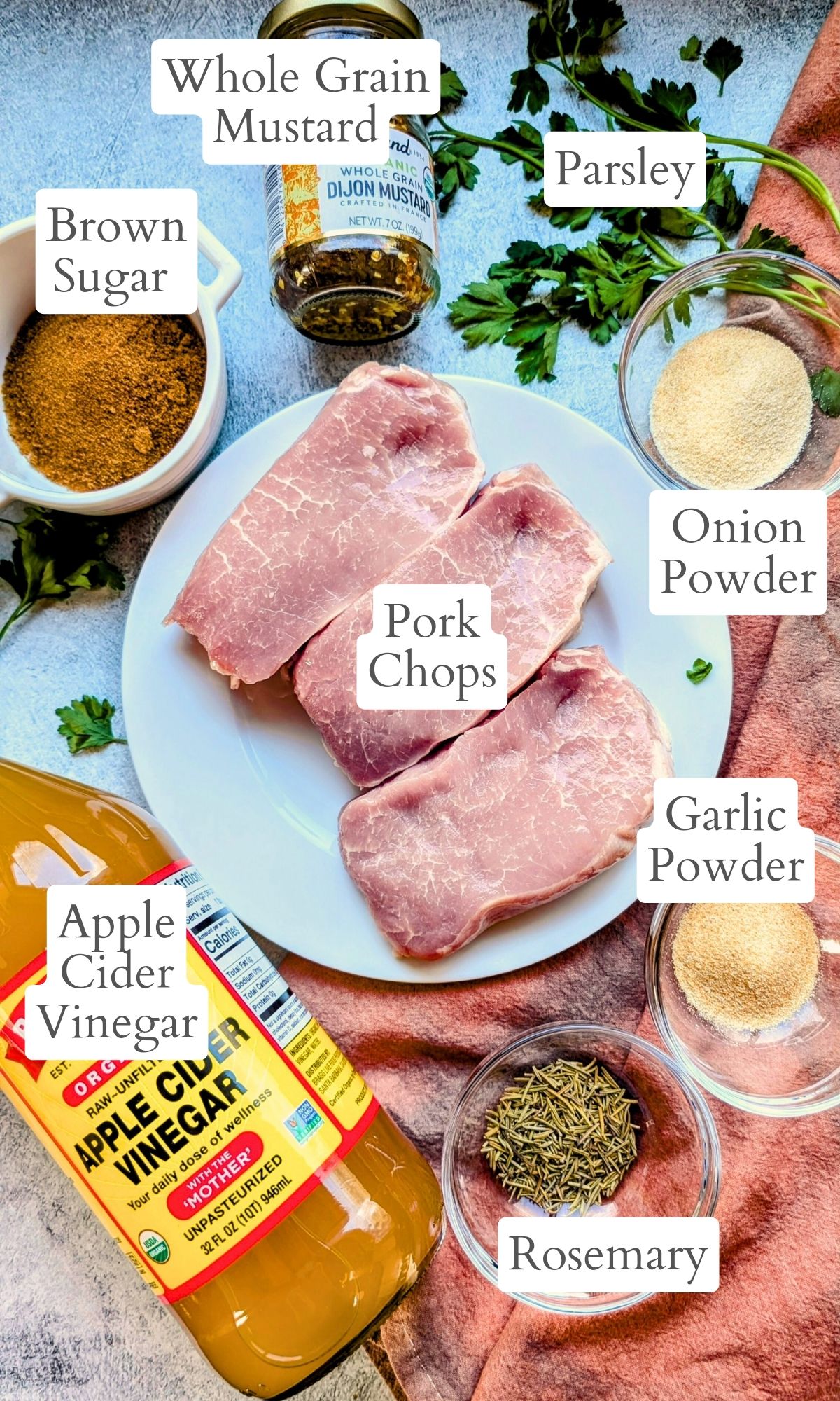 ingredients for low sodium pork chope like apple cider vinegar, onion powder, brown sugar, rosemary, and garlic powder.