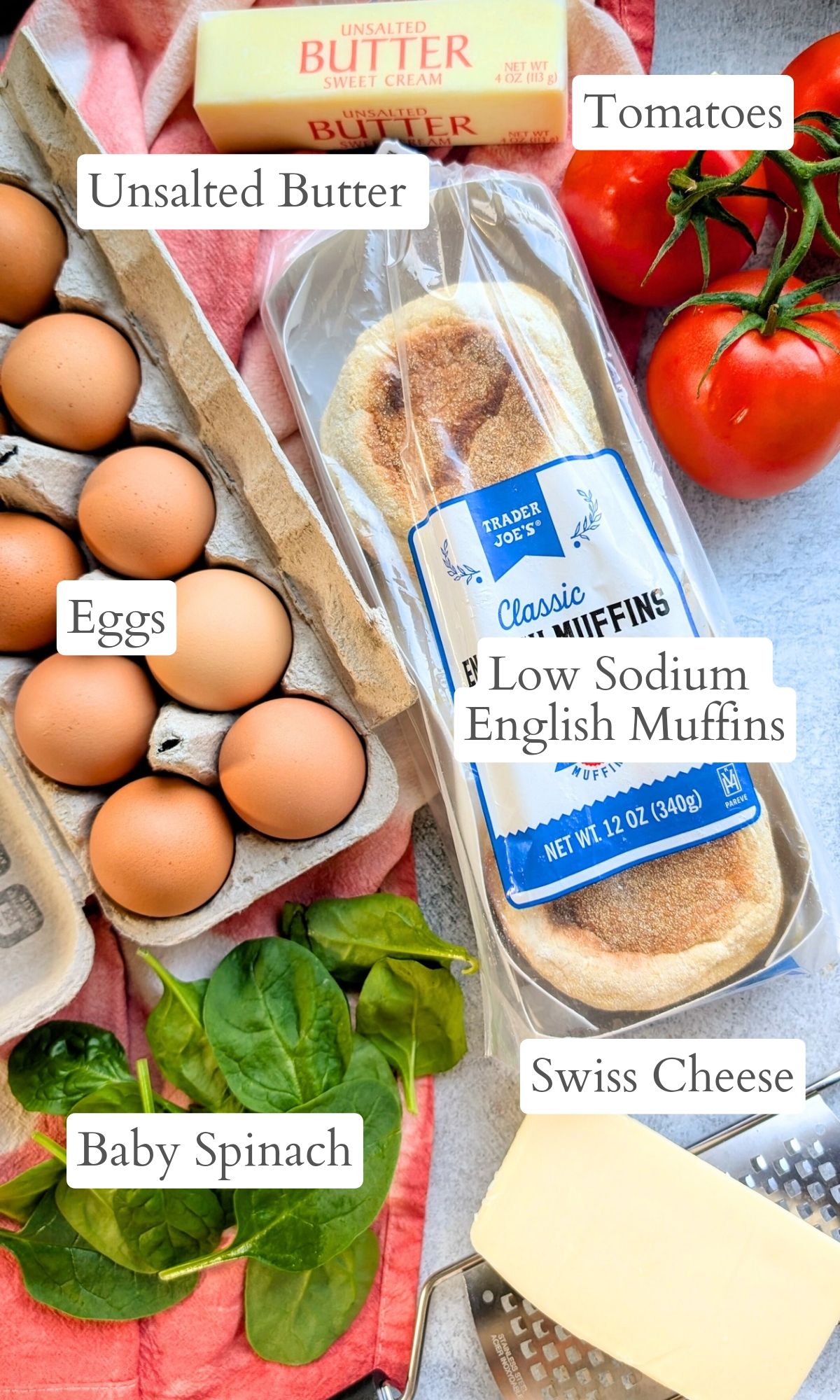 ingredients for low sodium breakfast sandwiches like eggs, english muffins, tomato, spinach, and swiss cheese