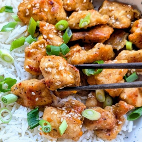 low sodium asian chicken with chopsticks and sesame seeds with rice and green onions