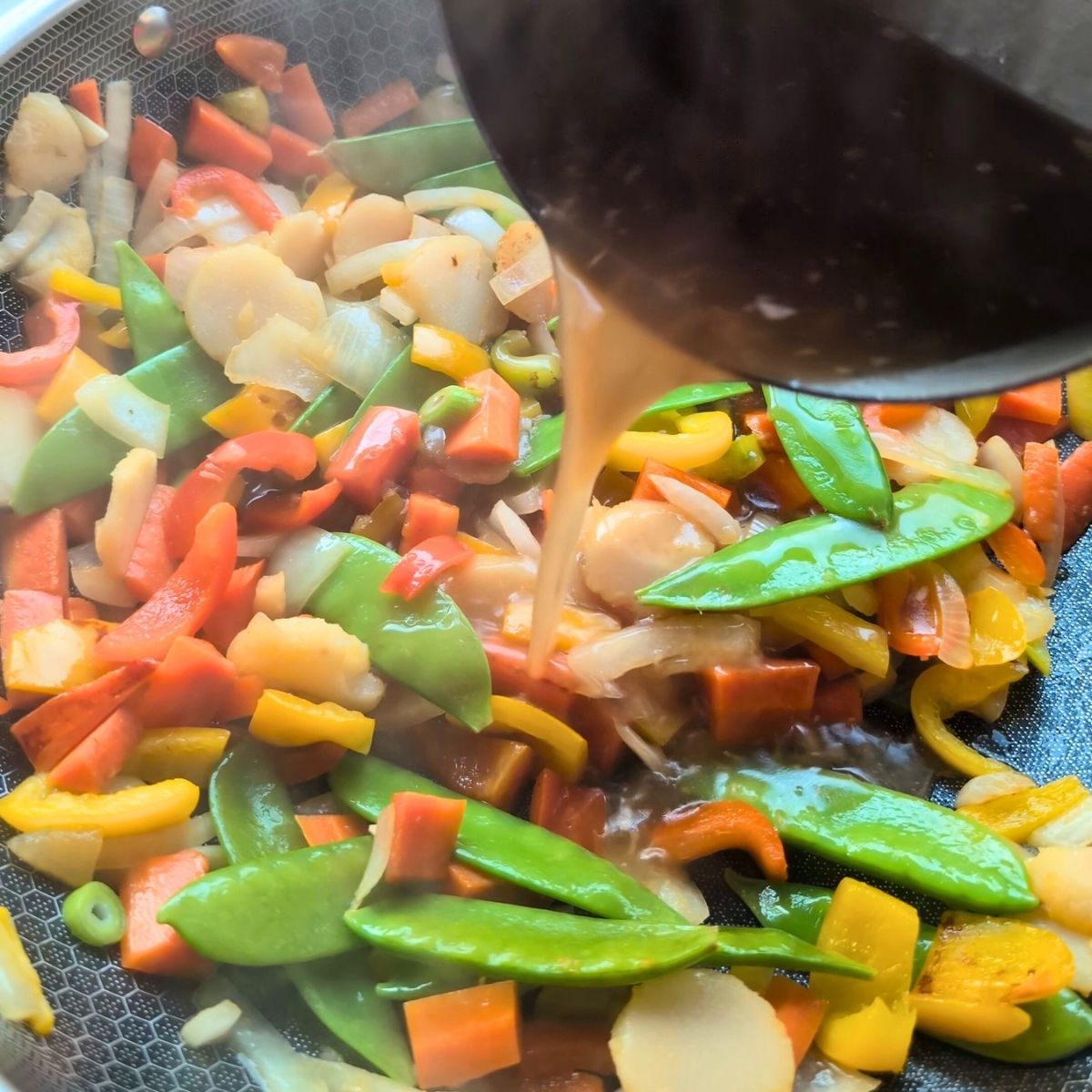 no salt added stir fry sauce added to a wok with vegetables for a low sodium dinner side dish recipe