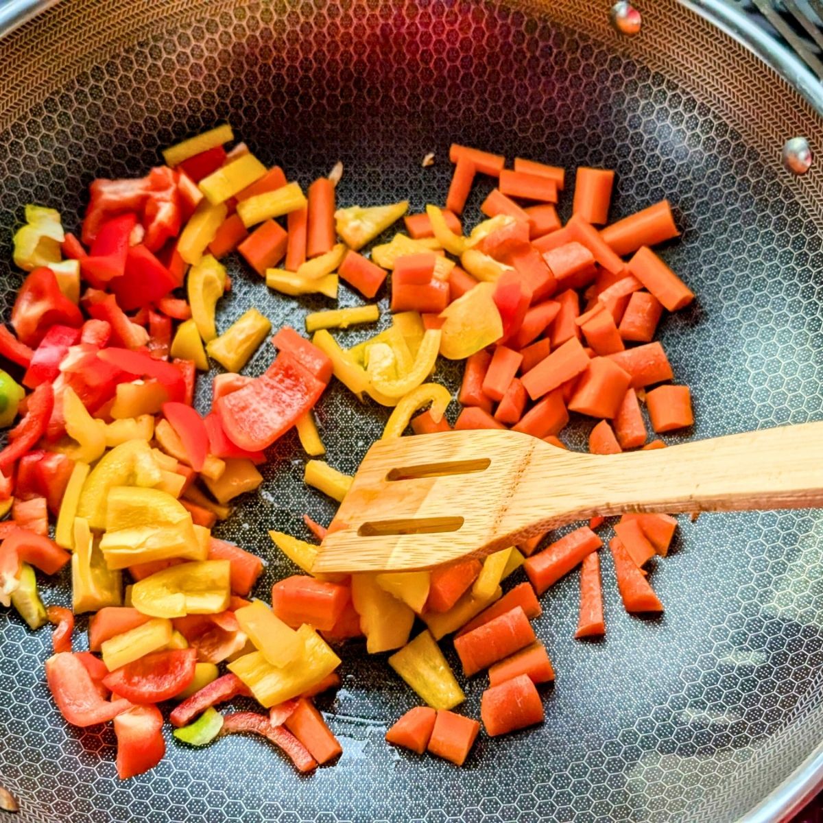 a wok with bell pepper and carrots to make a low sodium asian stir fry recipe