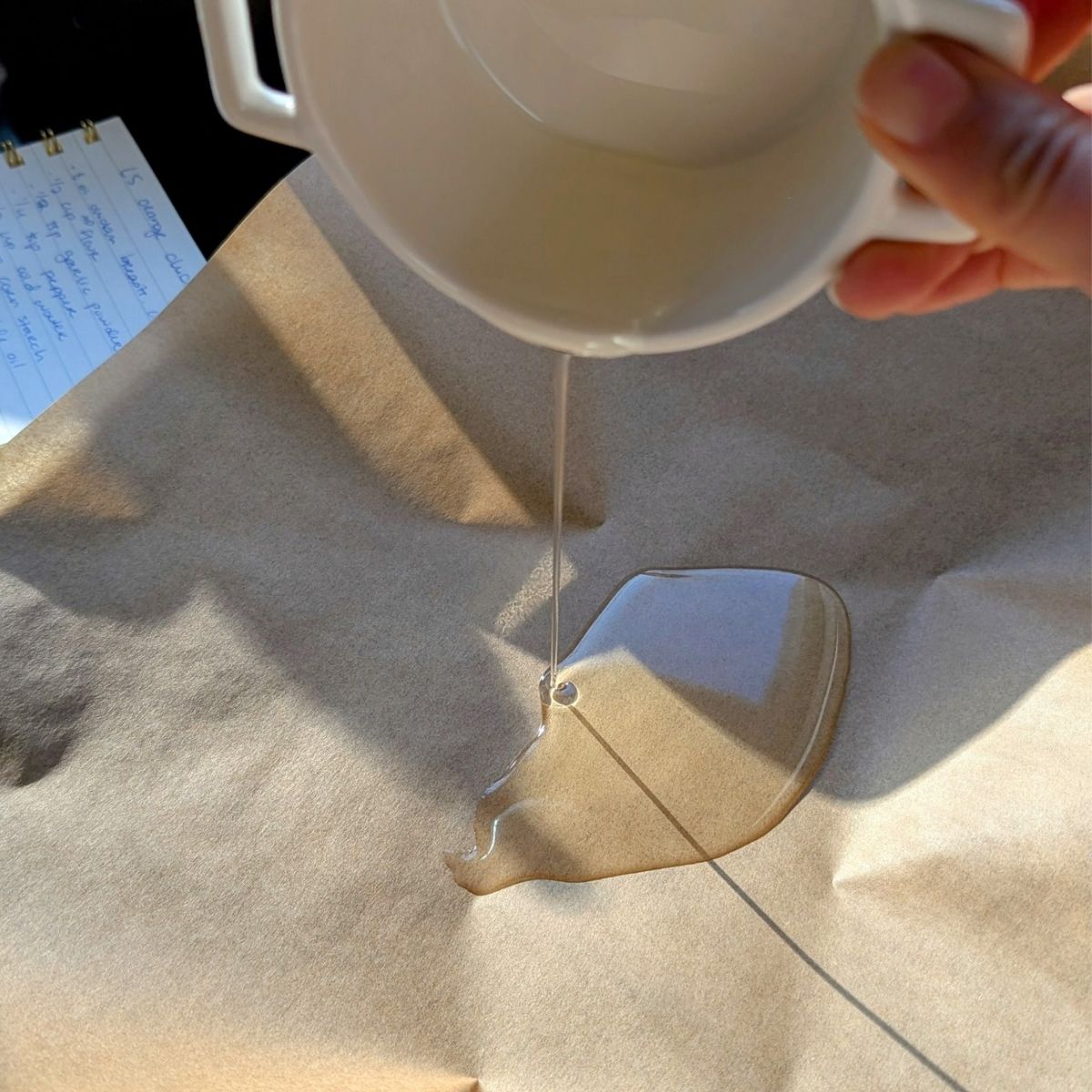 vegetable oil being poured on a sheet pan coated with parchment paper