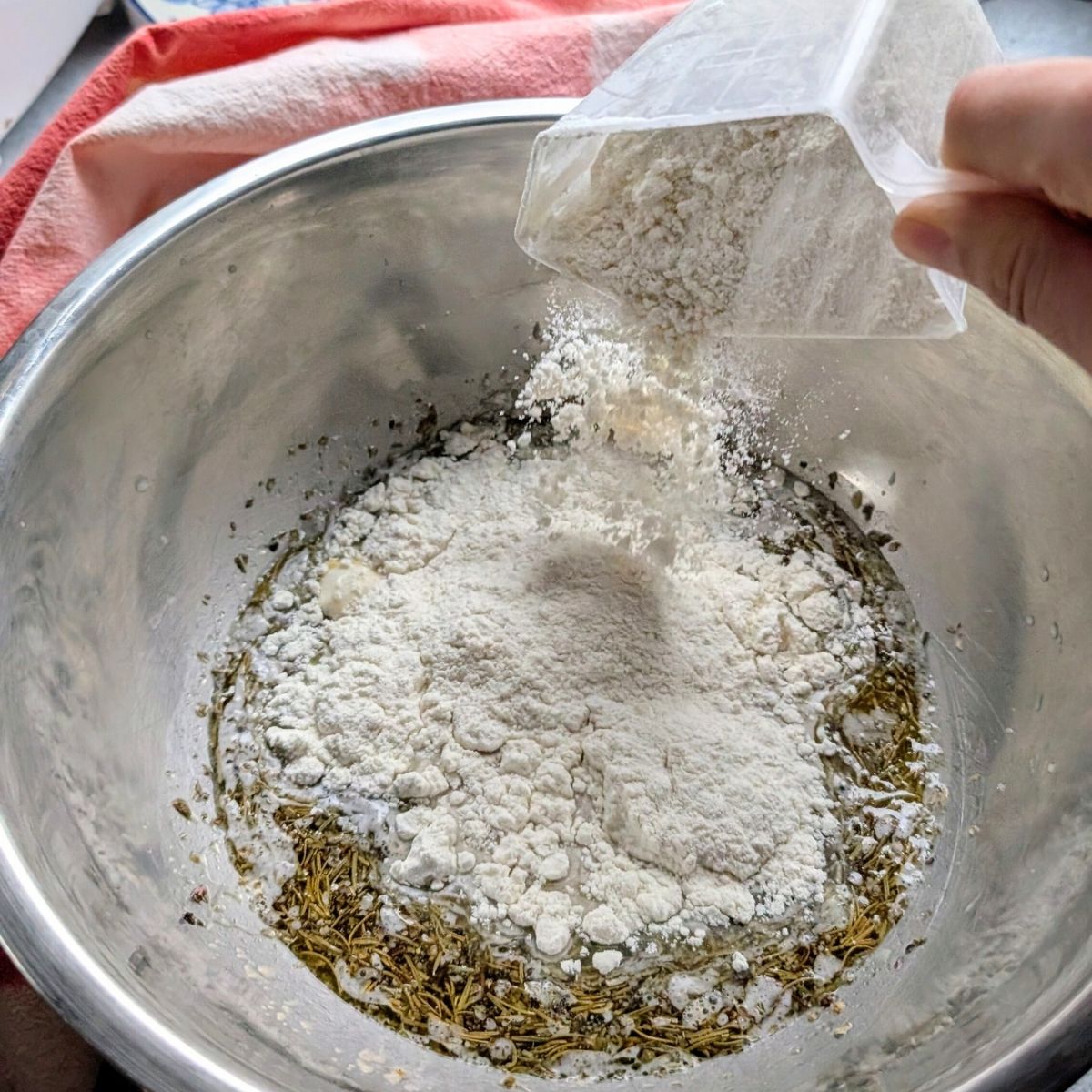 low salt pizza dough being mixed with all purpose white flour in a bowl for pizza night.