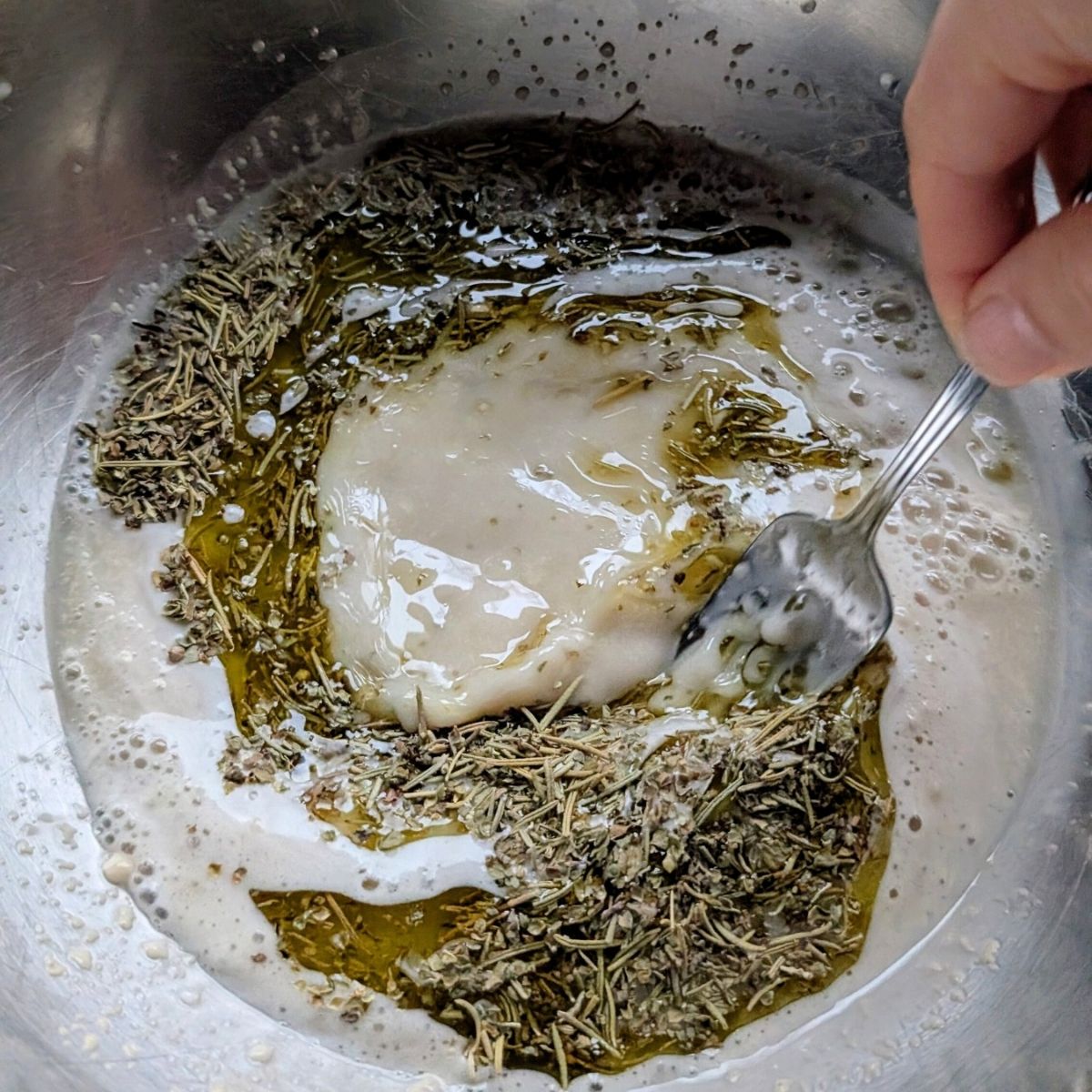 salt free pizza dough mixed in a bowl with olive oil garlic herbs and yeast