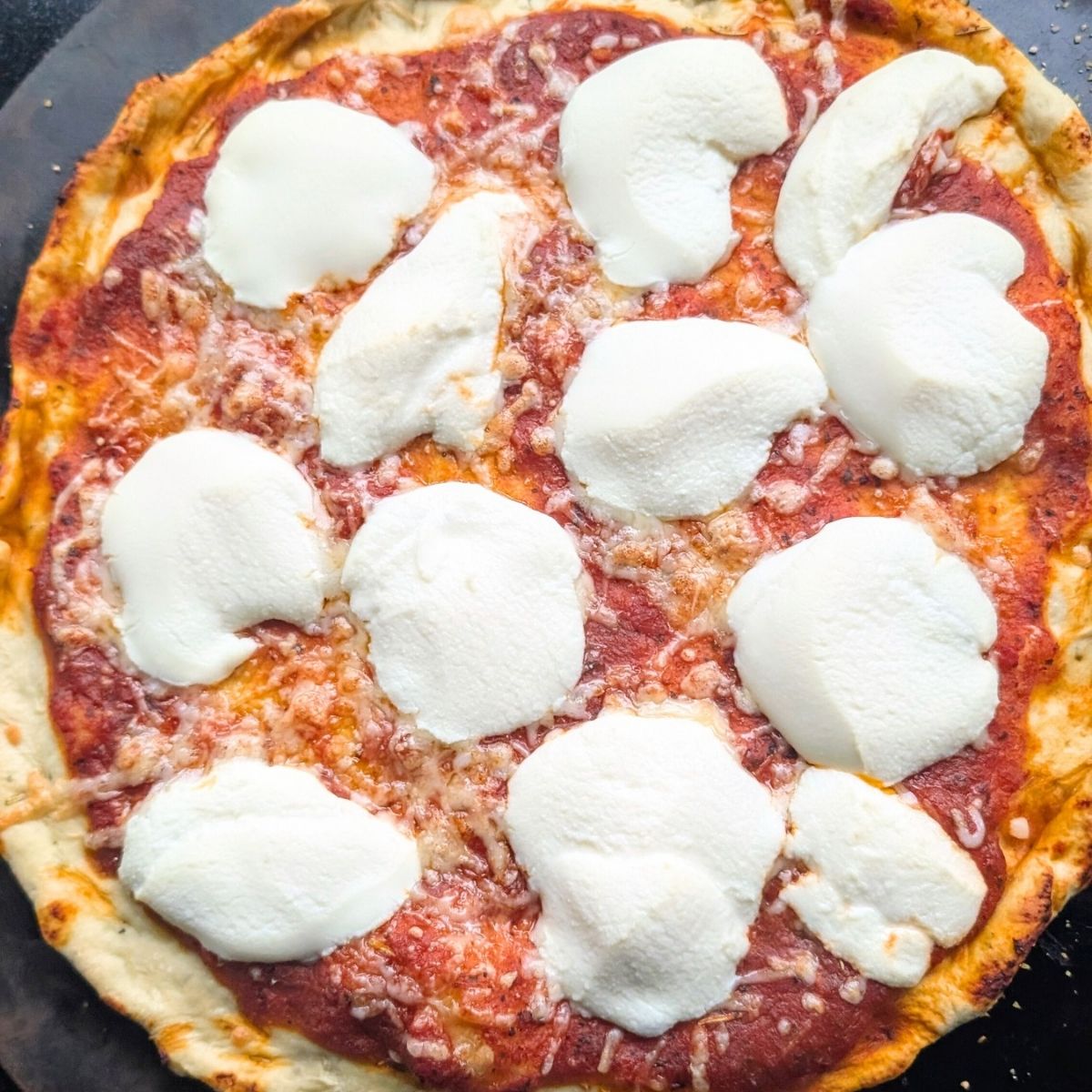 a pizza baked with unsalted pizza sauce, no salt pizza dough, and ricotta cheese.