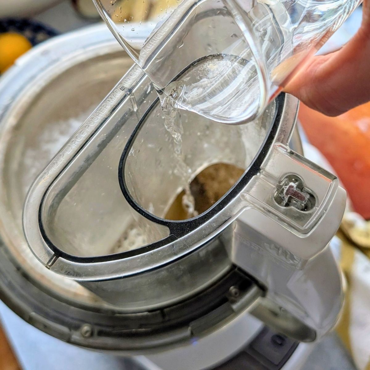 cold water being added to a food processor to make no salt pie crust