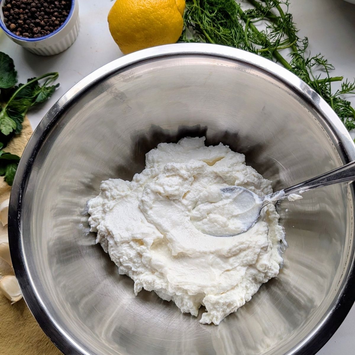 greek yogurt in a bowl ready to make low sodium cucumber sauce