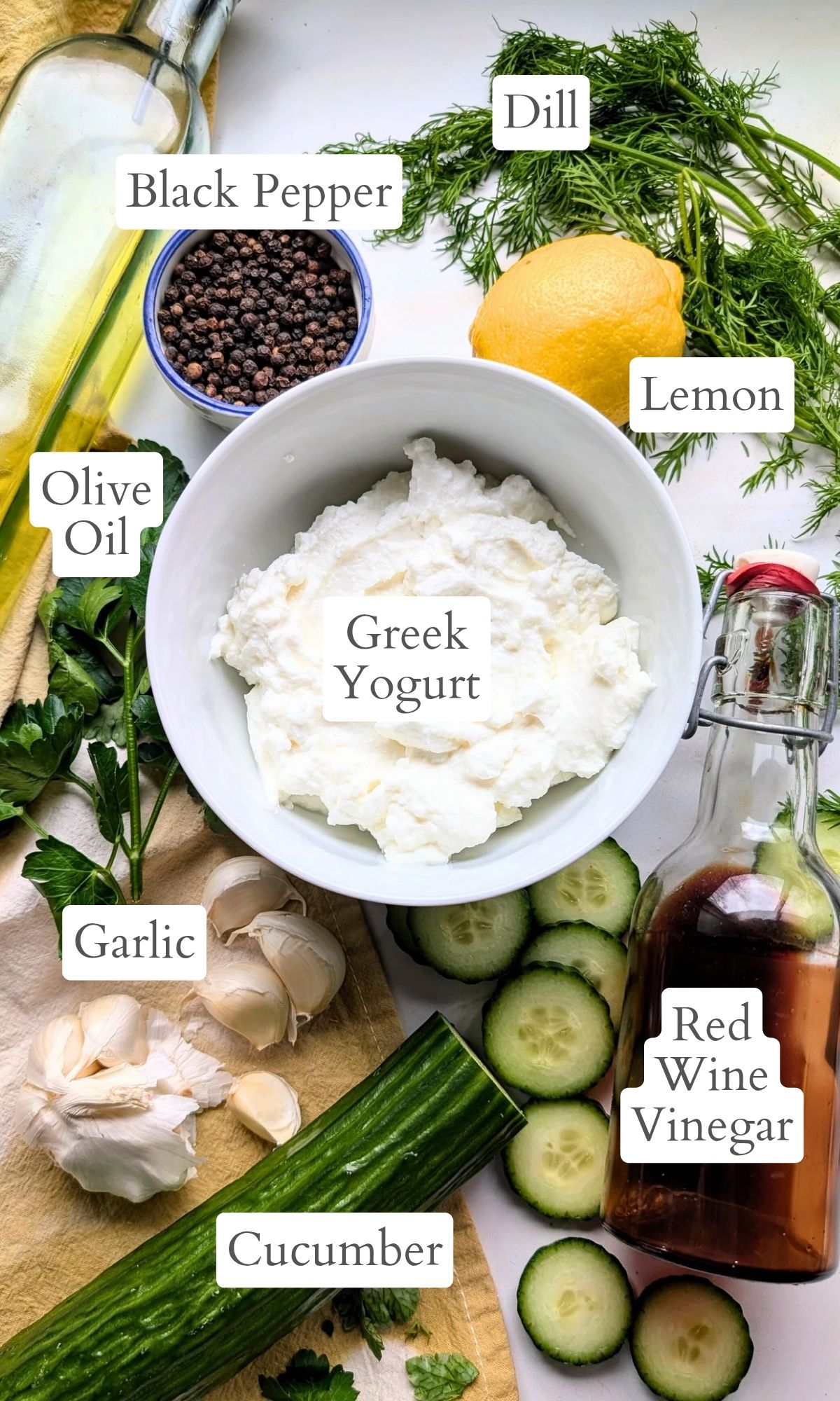 ingredients for low sodium cucumber yogurt sauce like greek yogurt, red wine vinegar, garlic, and lemon juice.