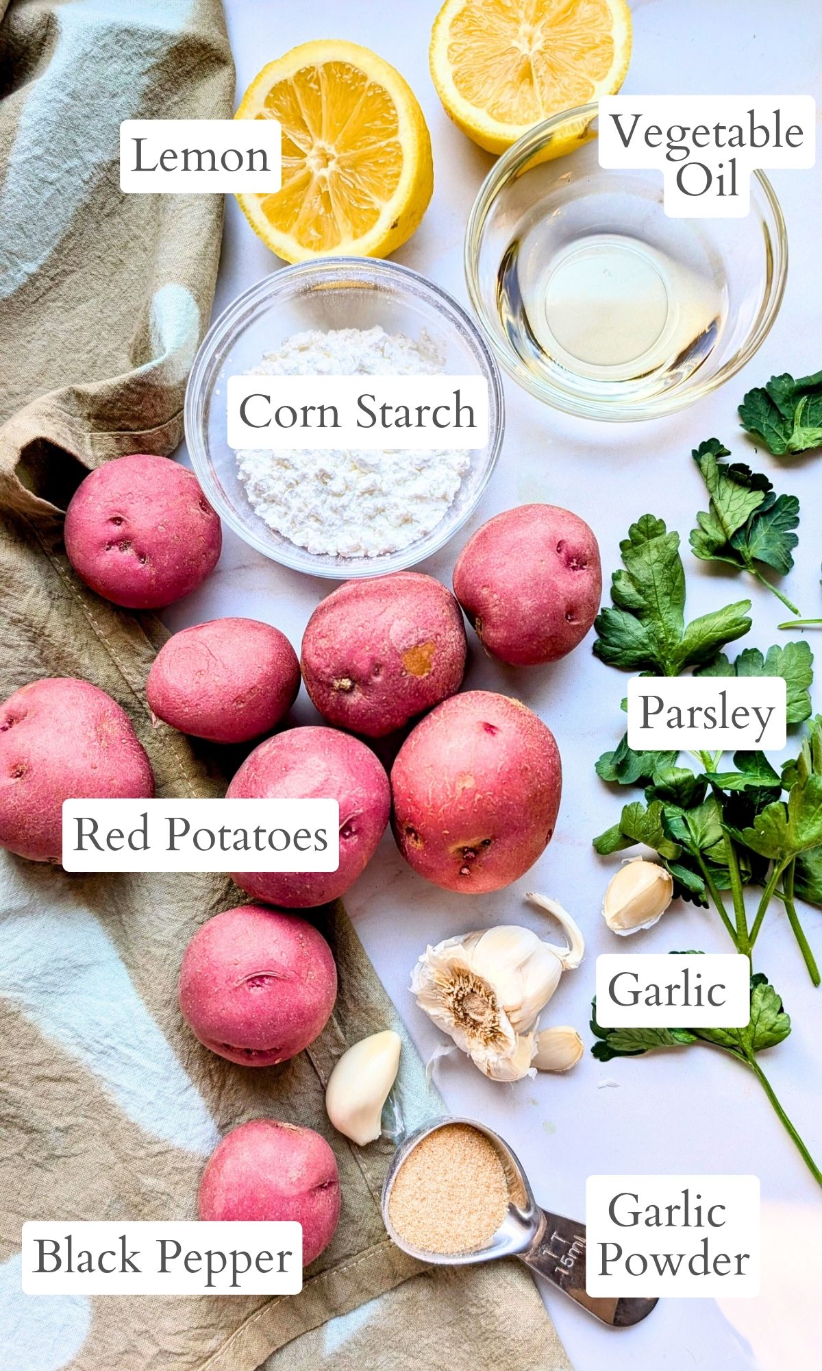 ingredients for garlic roasted potatoes like lemon cornstarch parsley and garlic powder.