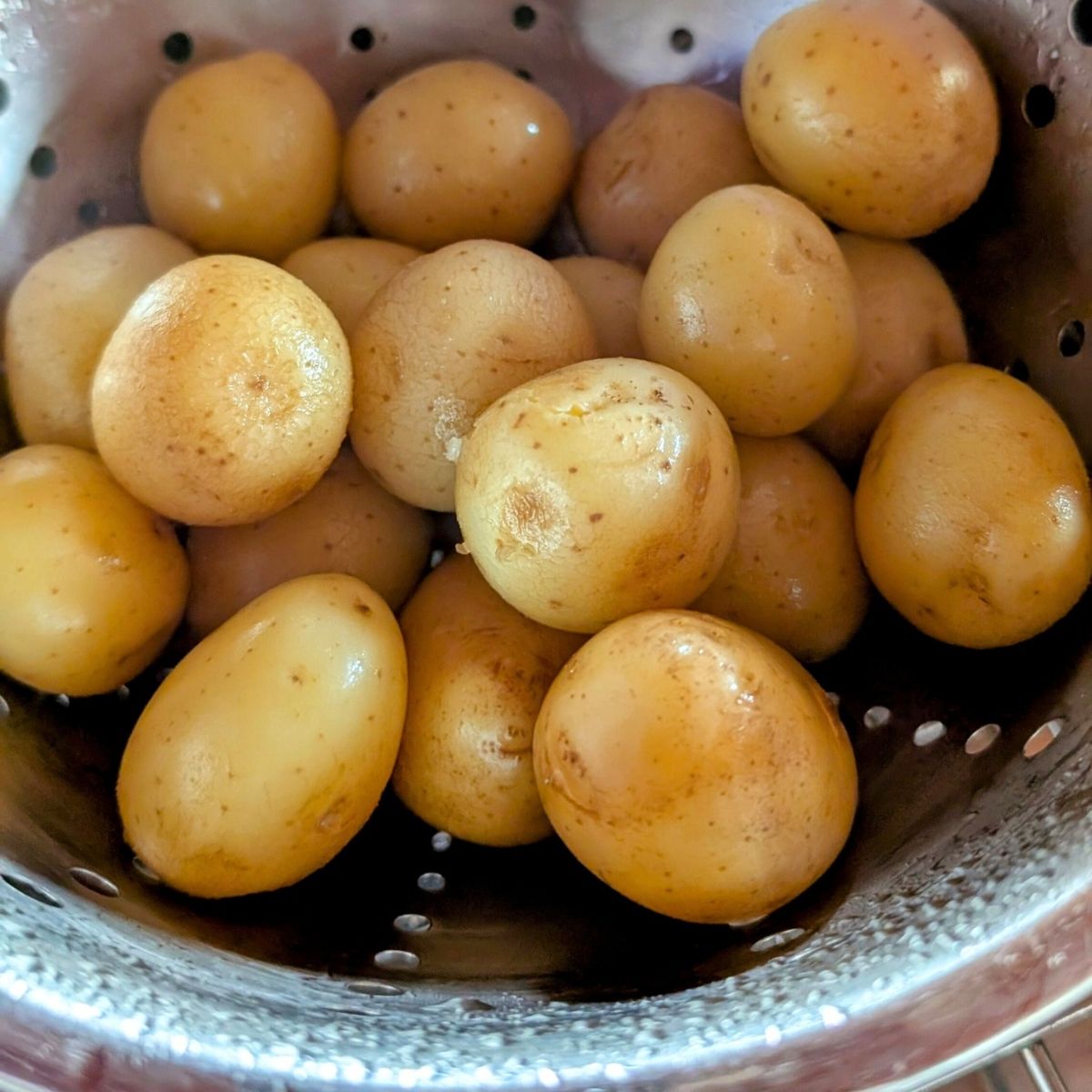 baby potatoes in a collander draining to make low sodium potatoes baked int he oven.